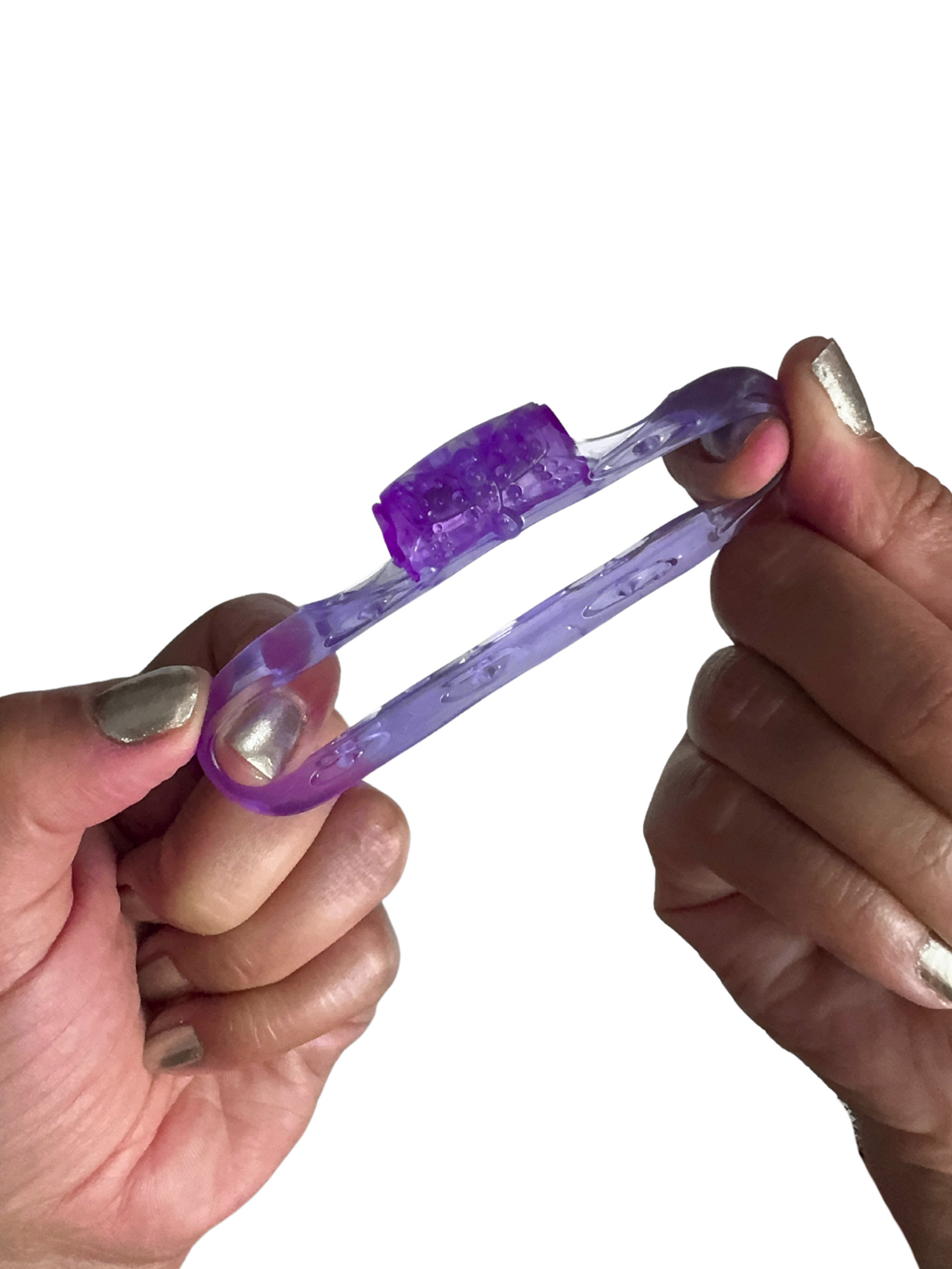 Flexible vibrating cock ring being stretched by hands