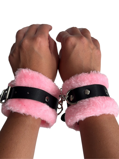 Soft pink furry handcuffs secured on wrists, perfect for beginner bondage and gender-inclusive sensual play.