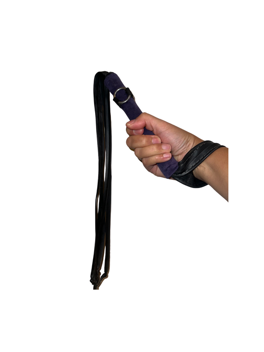 Hand holding the luxurious Purple Velvet Vegan Flogger, made from recycled bike tires and eco-conscious materials.