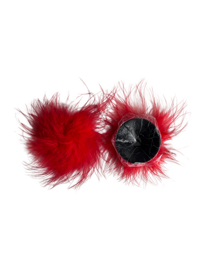 Reusable red fur nipple covers showing soft black adhesive backing, stick-on pasties for burlesque or performance.