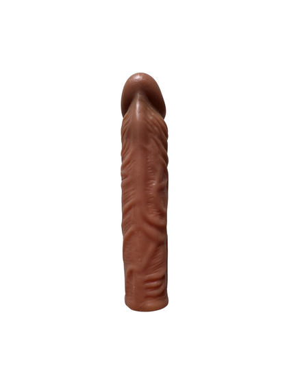 Front view of realistic penis sleeve extension in brown silicone – textured, flexible and body-safe