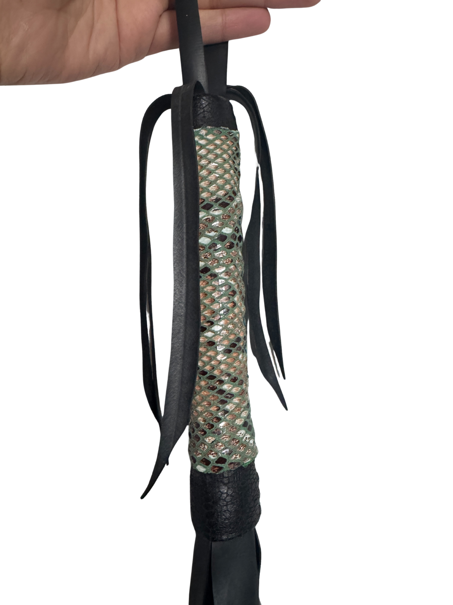 Close-up of vegan flogger handle with textured green and black faux leather grip