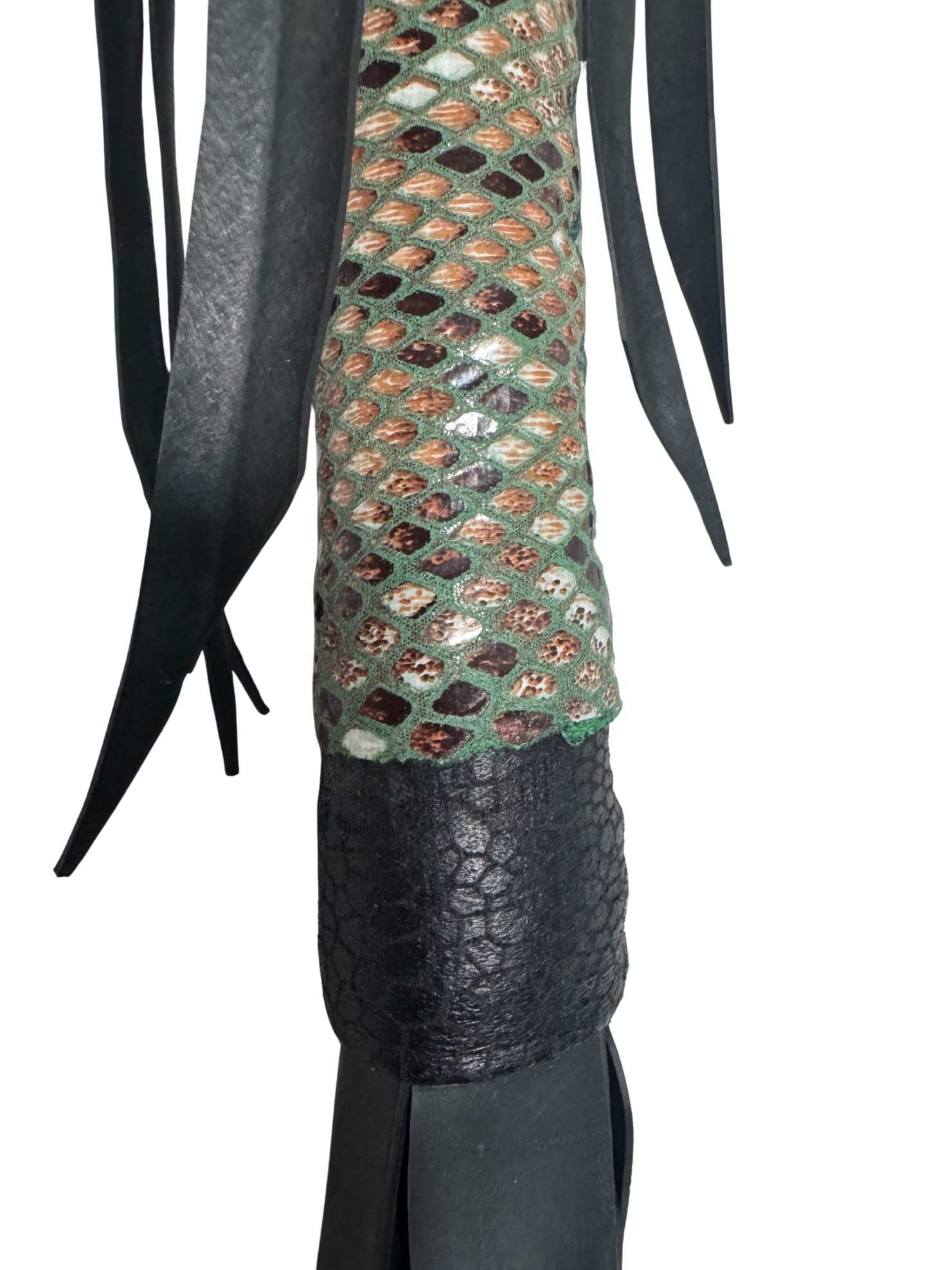 Detail of vegan flogger's reptile-patterned grip and soft faux leather falls