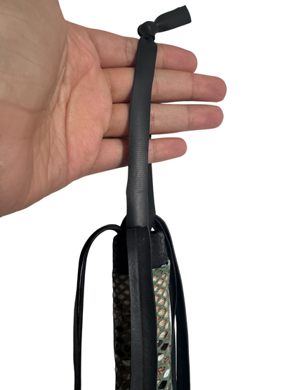 Hand holding flogger showing secure black wrist loop and top detail